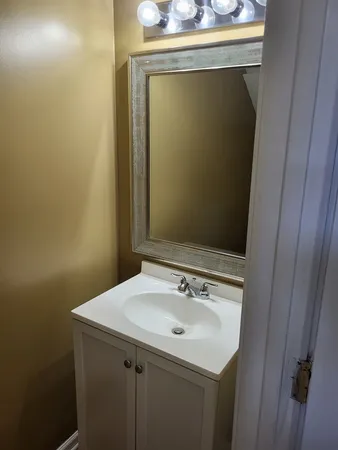 a bathroom with a sink and mirror