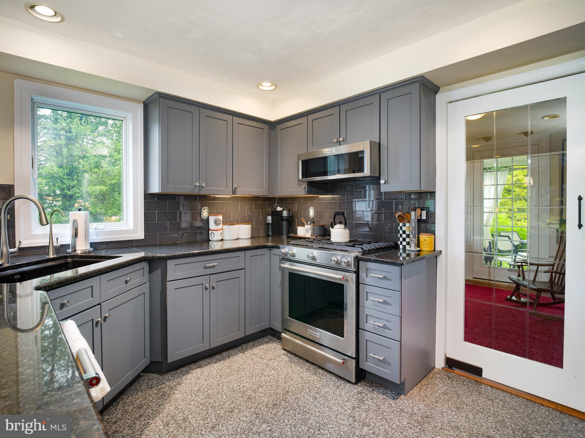 442 Old Eagle School Road Wayne, PA 19087 - Photo 11 of 39 a kitchen with stainless steel appliances granite countertop a stove a sink and a microwave