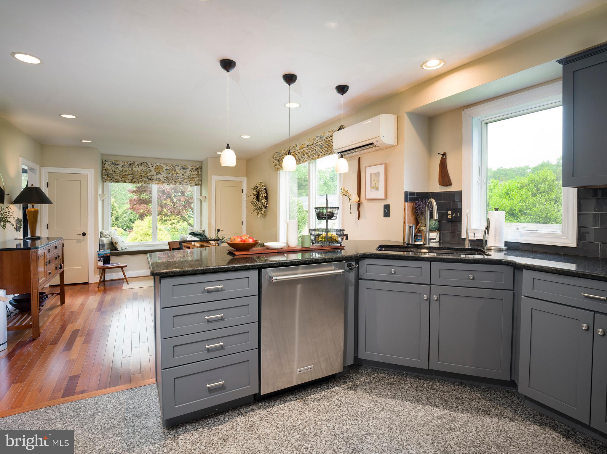 442 Old Eagle School Road Wayne, PA 19087 - Photo 14 of 39 a kitchen with granite countertop a stove a sink a window and dining table