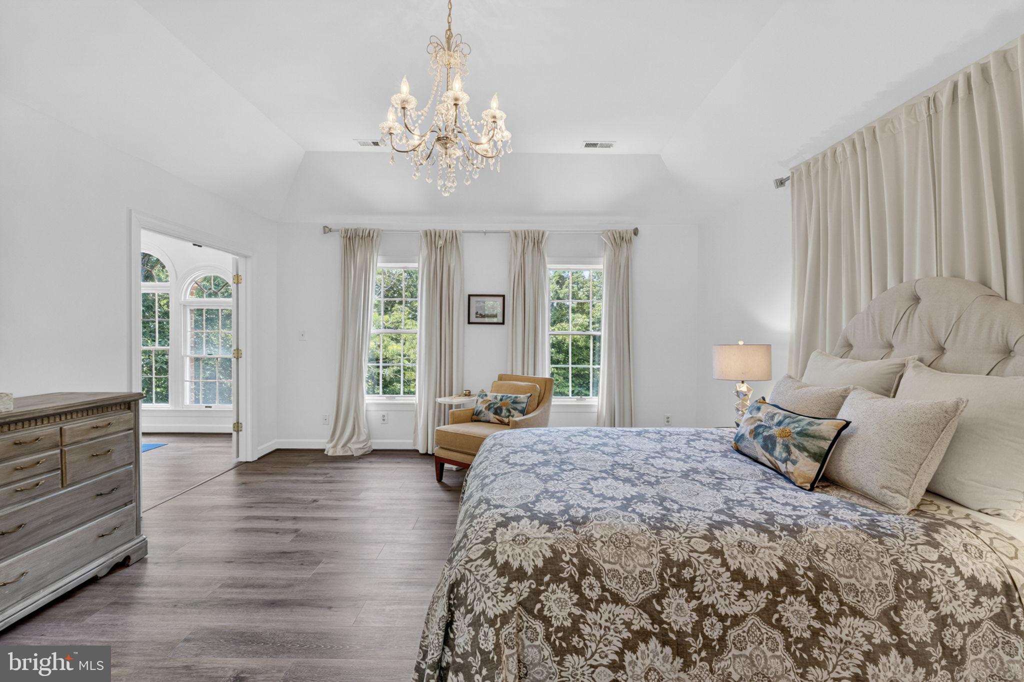 4531 Den Haag Road Warrenton, VA 20187 - Photo 46 of 103 a spacious bedroom with a balcony a bed and wooden floor