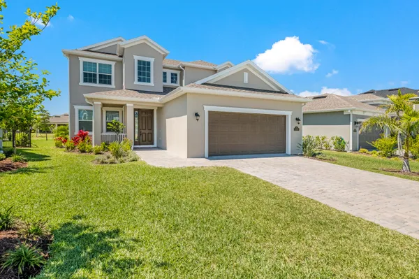 a front view of house with yard and green space