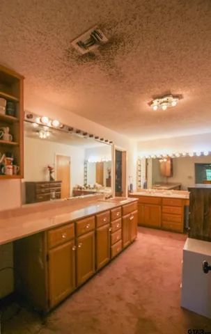 a large kitchen with stainless steel appliances granite countertop a lot of counter space and a sink