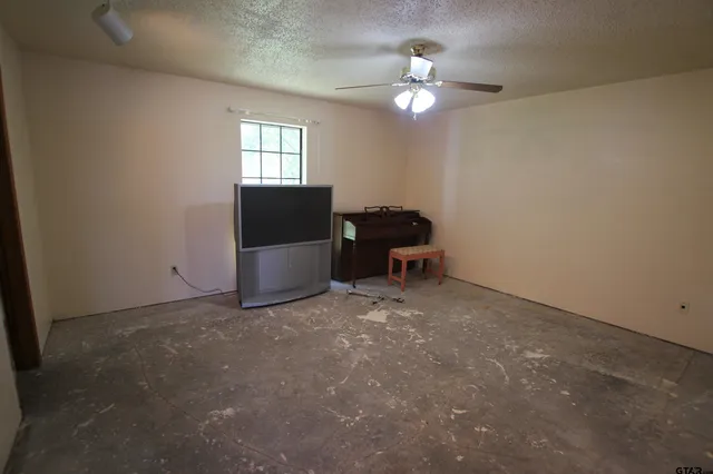 a view of a livingroom with furniture and chandelier fan