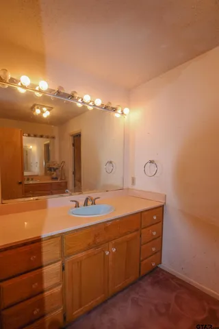 a spacious bathroom with a double vanity sink and a mirror