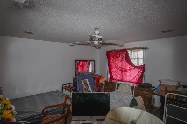 a living room with furniture a flat screen tv and a window