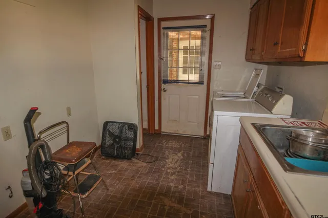 a kitchen with a sink a stove and cabinets