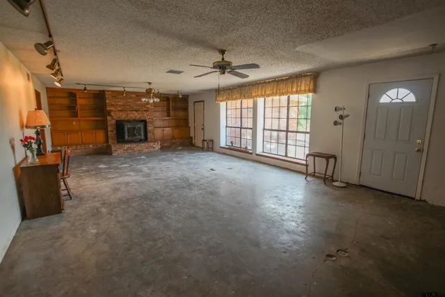 wooden floor in an empty room with a fireplace