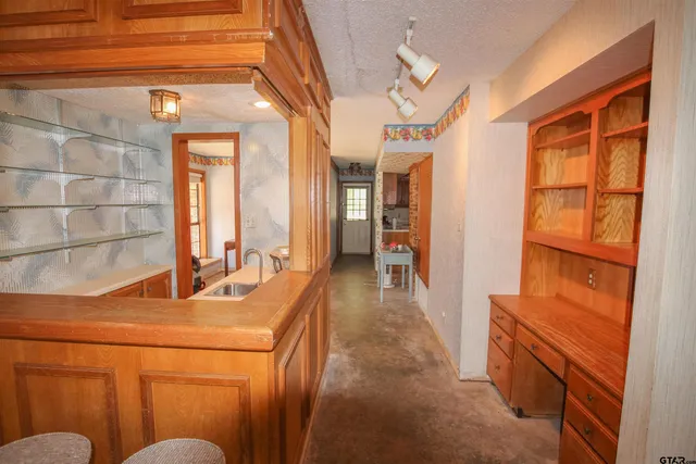 a hallway with a sink and a refrigerator