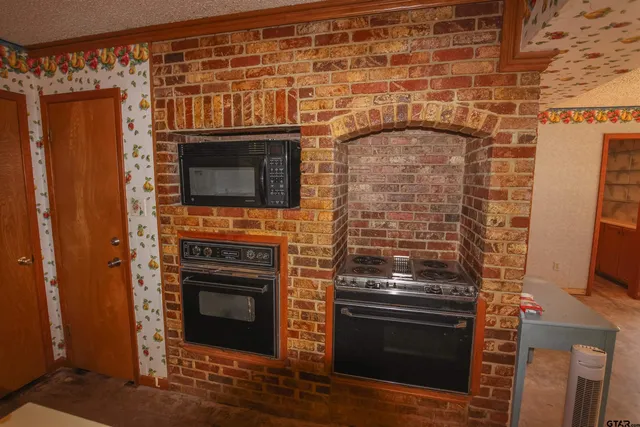 a stove top oven sitting inside of a kitchen