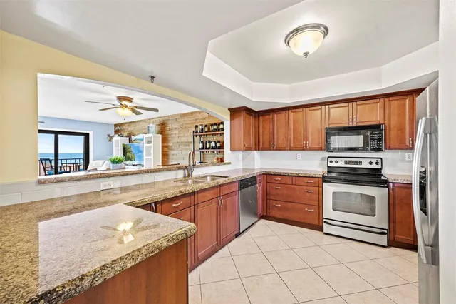 a kitchen with stainless steel appliances granite countertop a stove sink and microwave
