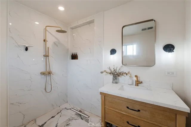 a bathroom with a sink a toilet and shower curtain