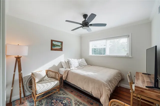 a bedroom with a bed and a tv on the table