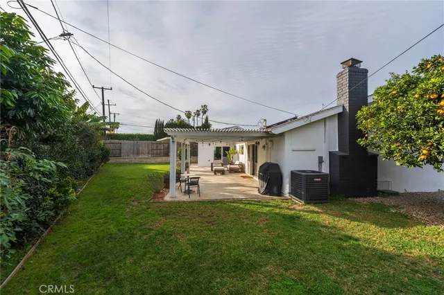 a view of a chair and table in backyard of the house