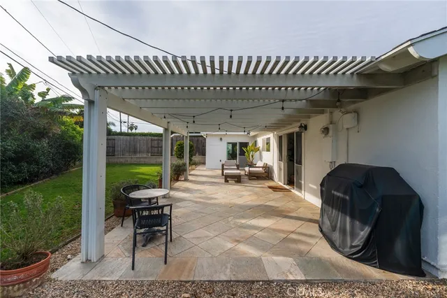 a view of a house with backyard sitting area and garden