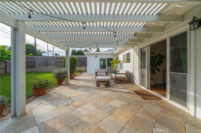a front view of a house with a garden and plants