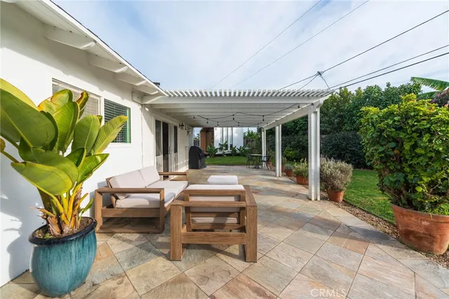 a view of a house with backyard sitting area and garden