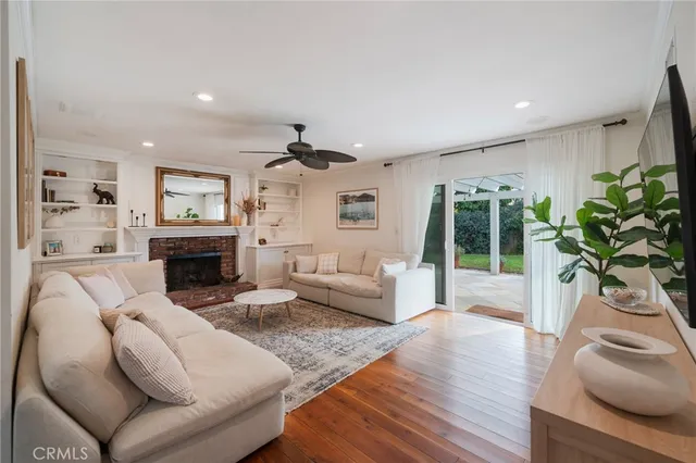 a living room with furniture a fireplace and a potted plant