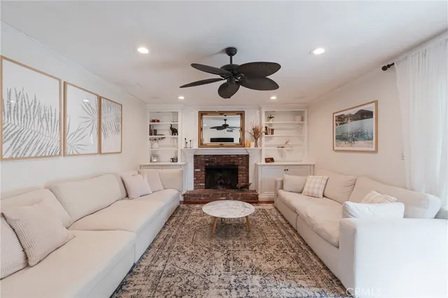 a living room with furniture a rug and a fireplace