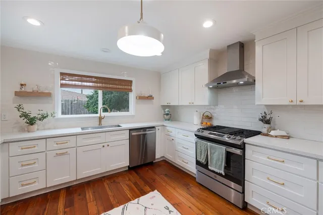 a kitchen with a sink stove and refrigerator