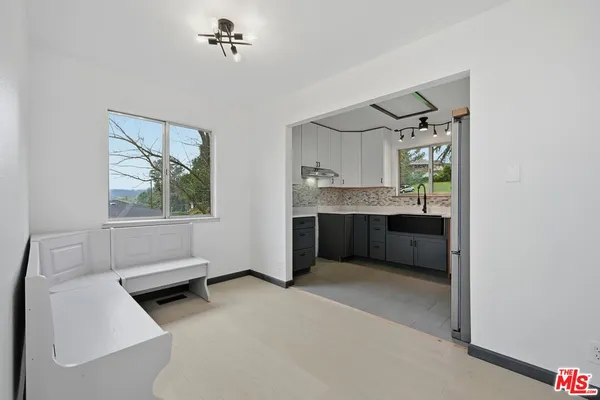 a kitchen with stainless steel appliances granite countertop a refrigerator sink and cabinets