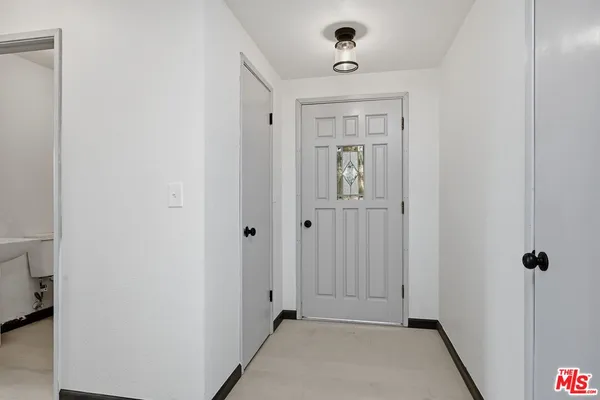 a view of a hallway with a white walls