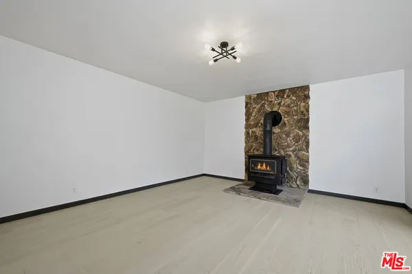 a view of an empty room with a fireplace