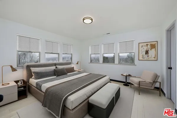 a bedroom with a bed and a lamp