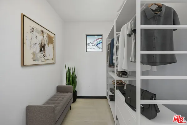 a bed room with a bed and a painting on the wall