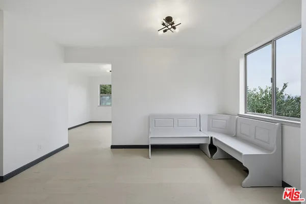 a view of room with workspace and windows
