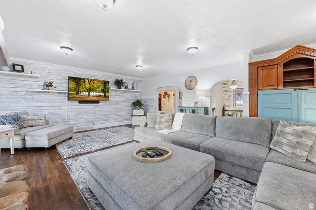 2342 Charros Road Sandy, UT 84092 - Photo 17 of 94 Spacious living area featuring wood-finish flooring, a shiplap accent wall, built-in shelving, and recessed lighting