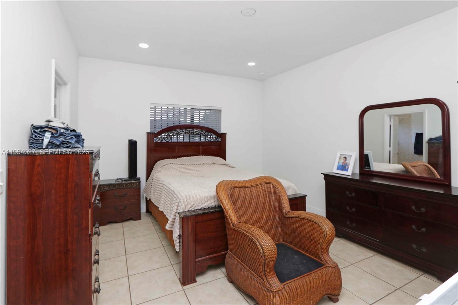 12245 Southwest 218th Street Miami, FL 33170 - Photo 13 of 32 a bedroom with furniture and wooden floor