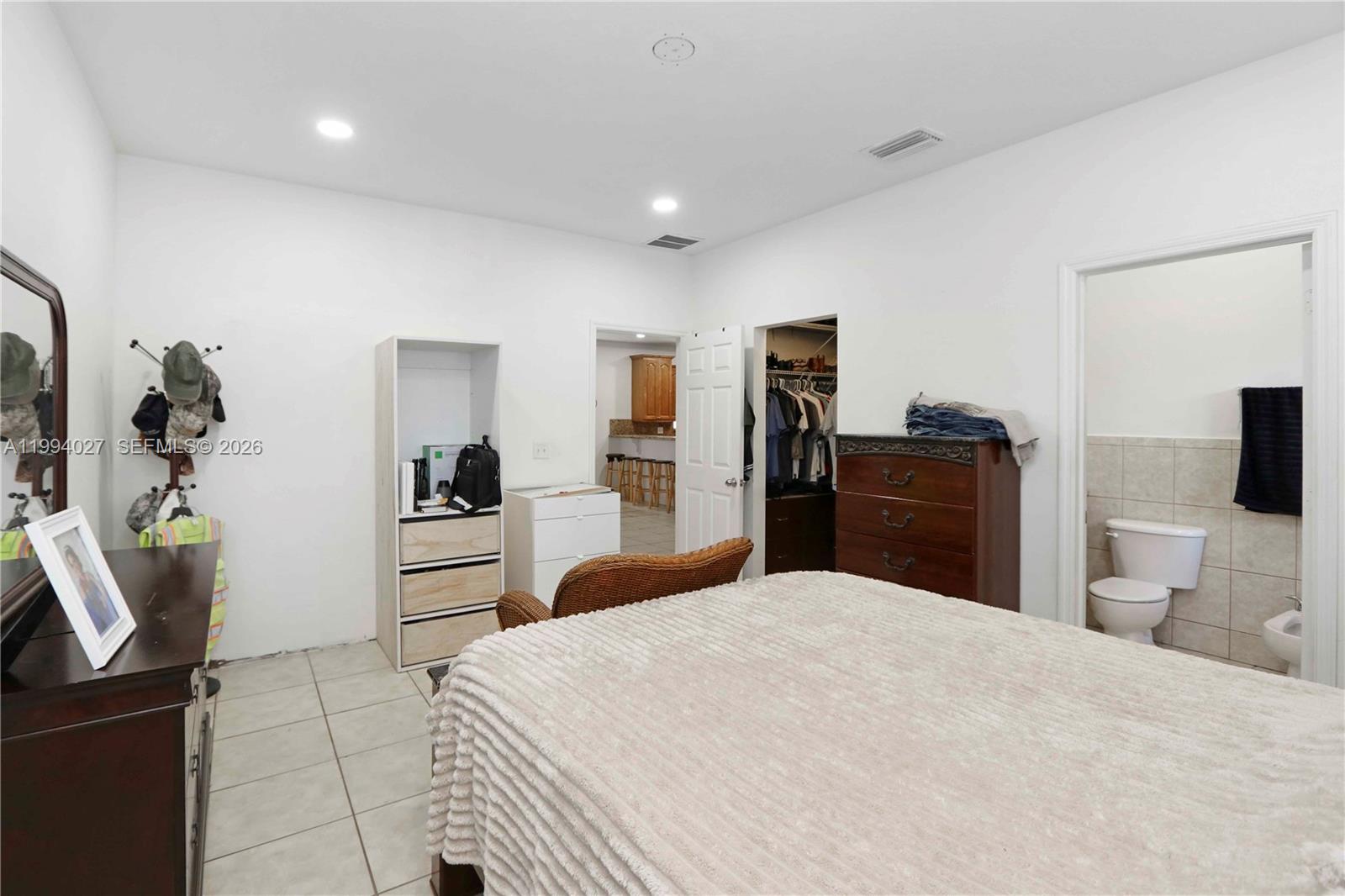 12245 Southwest 218th Street Miami, FL 33170 - Photo 14 of 32 a bedroom with a bed and furniture