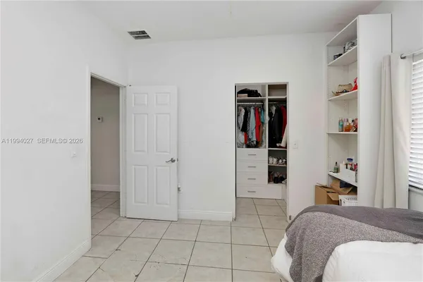 a view of a bedroom with closet and cabinet