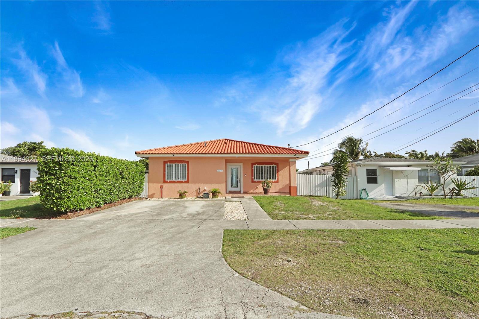 12245 Southwest 218th Street Miami, FL 33170 - Photo 2 of 32 a front view of a house with a yard