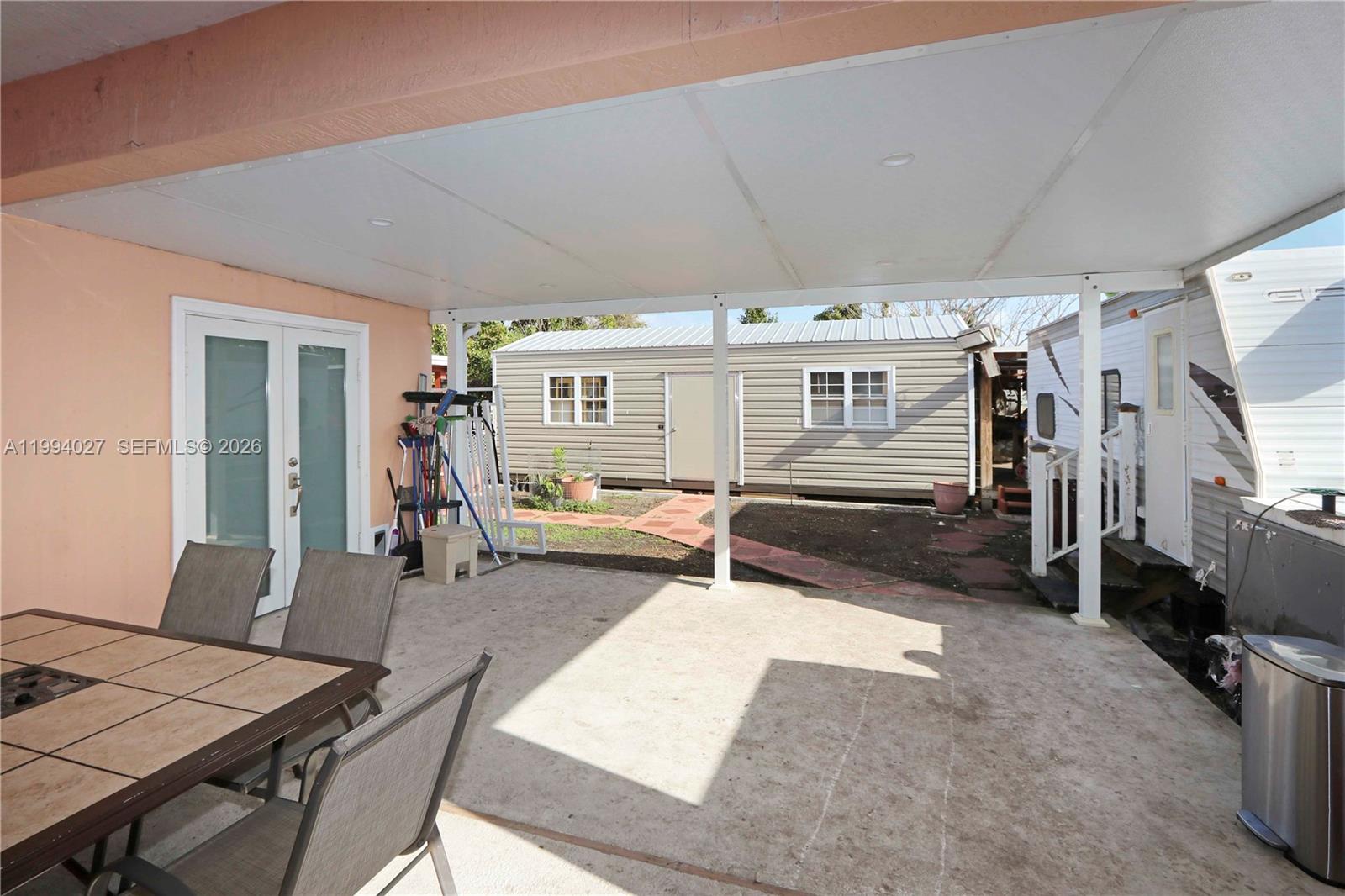 12245 Southwest 218th Street Miami, FL 33170 - Photo 23 of 32 a living room with furniture and a flat screen tv