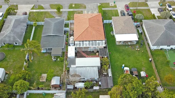 a view of backyard with swimming pool and seating