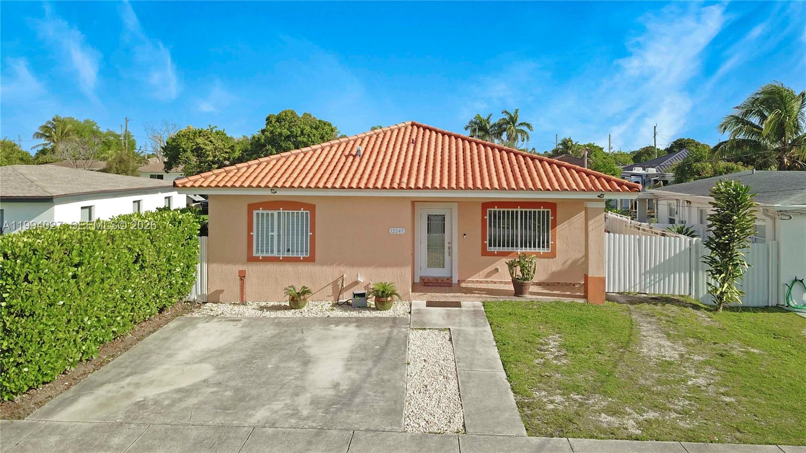 12245 Southwest 218th Street Miami, FL 33170 - Photo 32 of 32 a front view of a house with a yard
