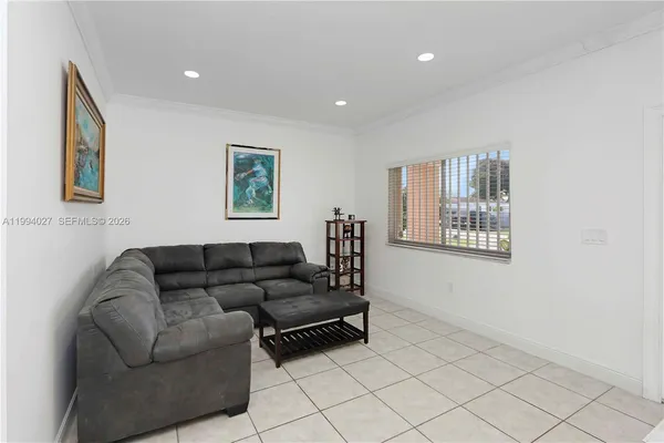 a living room with furniture and a wall painting