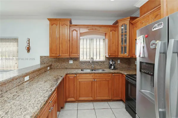 a kitchen with a sink stove and refrigerator