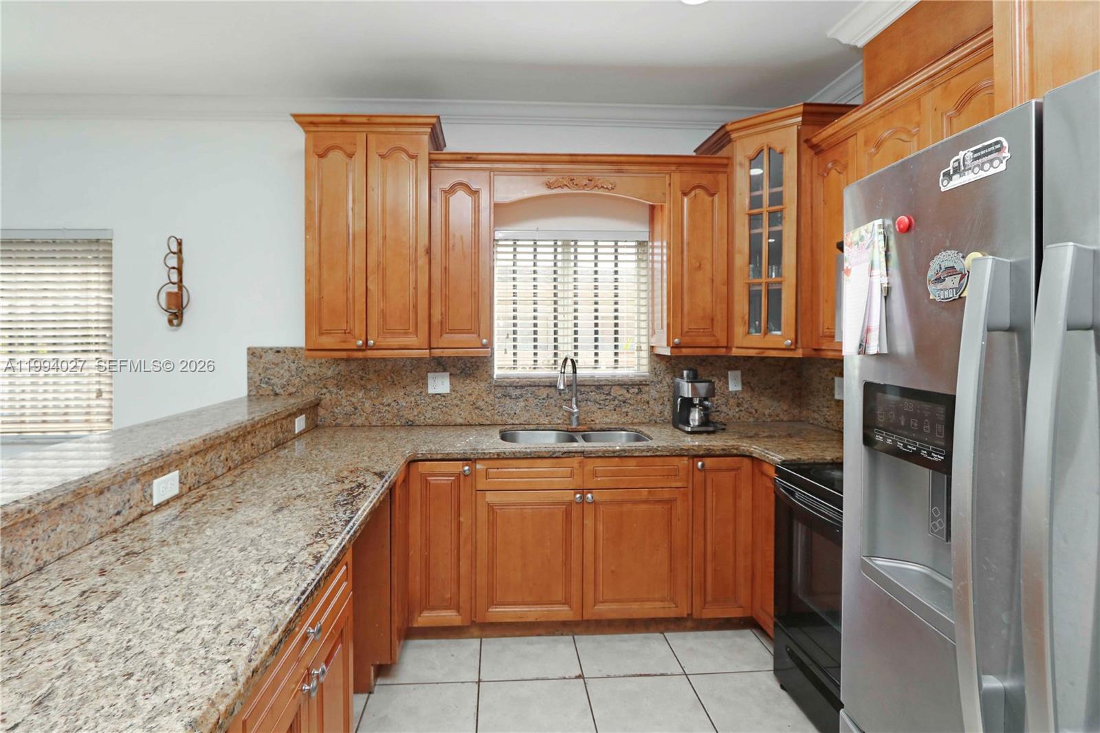 12245 Southwest 218th Street Miami, FL 33170 - Photo 8 of 32 a kitchen with a sink stove and refrigerator