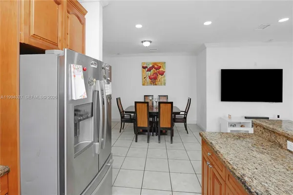 a kitchen with stainless steel appliances granite countertop a refrigerator and a stove top oven