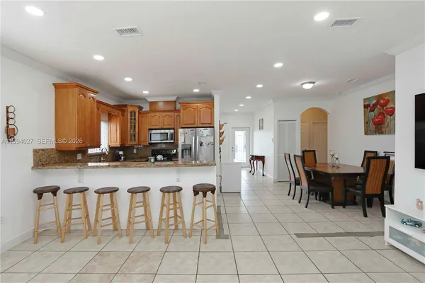 a large kitchen with a table and chairs