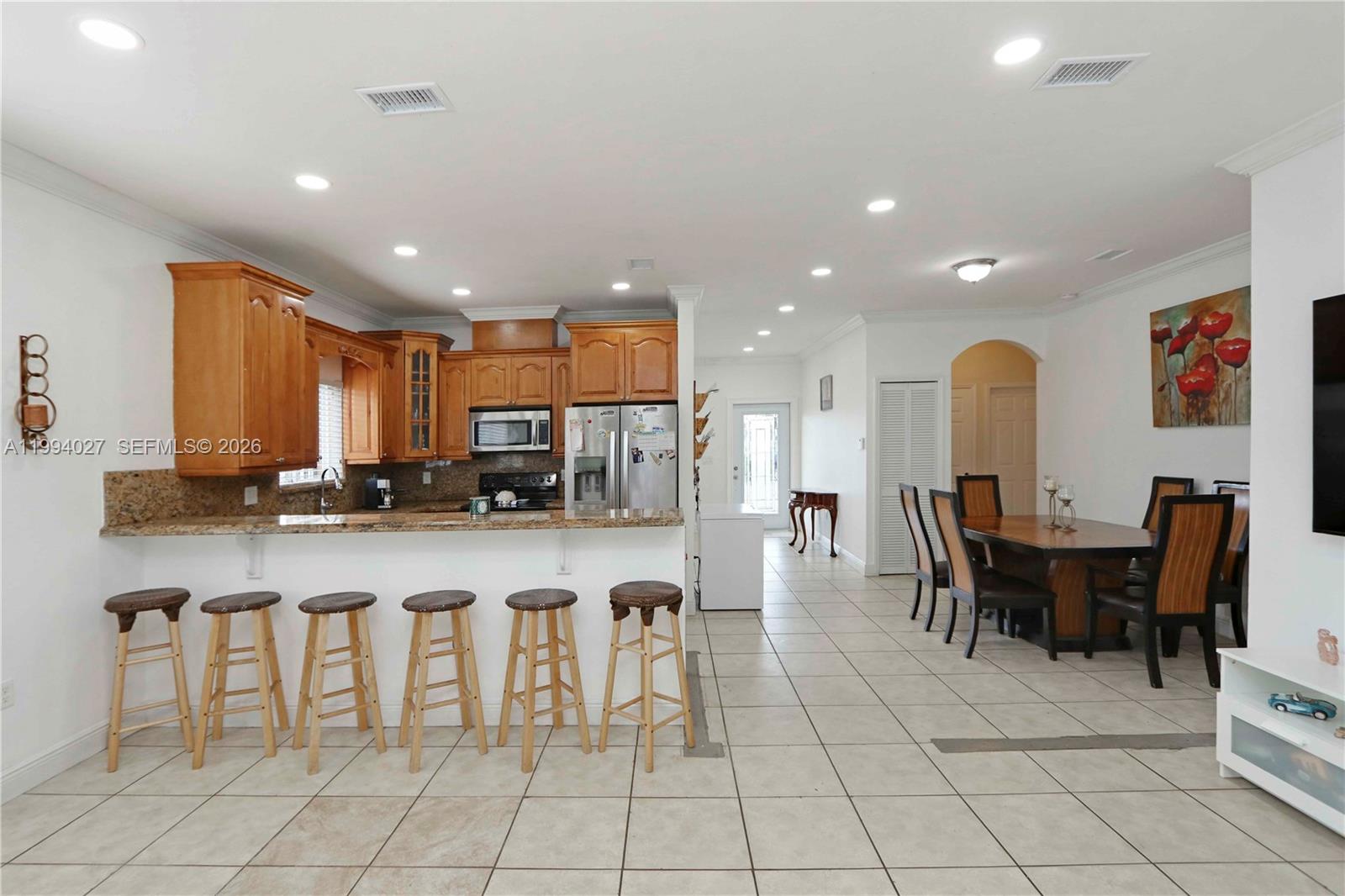 12245 Southwest 218th Street Miami, FL 33170 - Photo 10 of 32 a large kitchen with a table and chairs