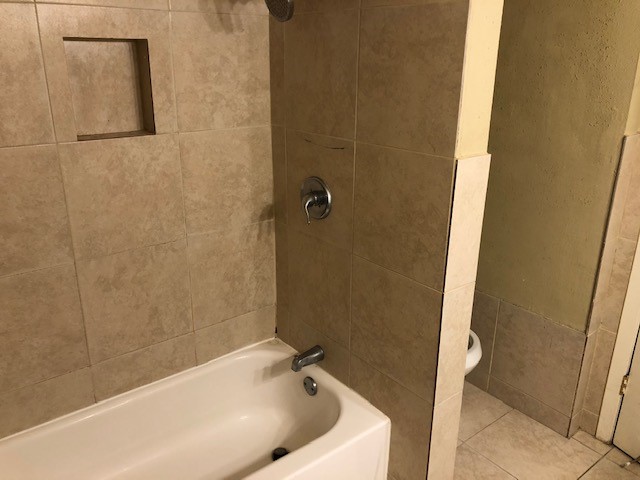 1901 South Voss Road, Unit 61 Houston, TX 77057 - Photo 19 of 22 a bathroom with a tub and shower