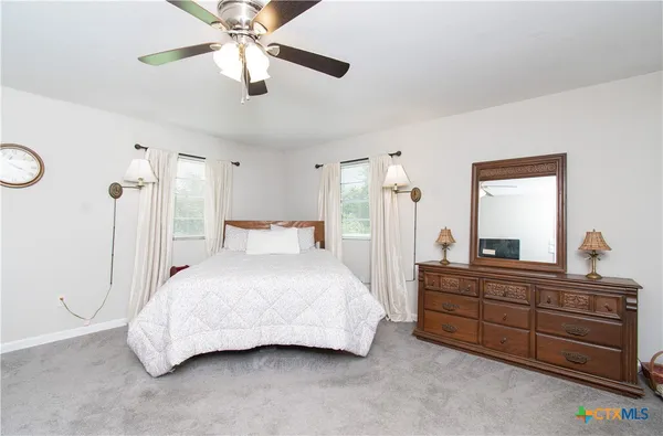 a bedroom with a bed and a dresser