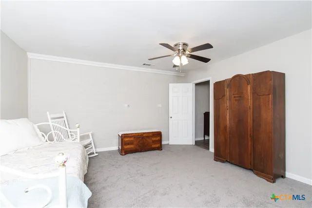a furnished livingroom with a ceiling fan