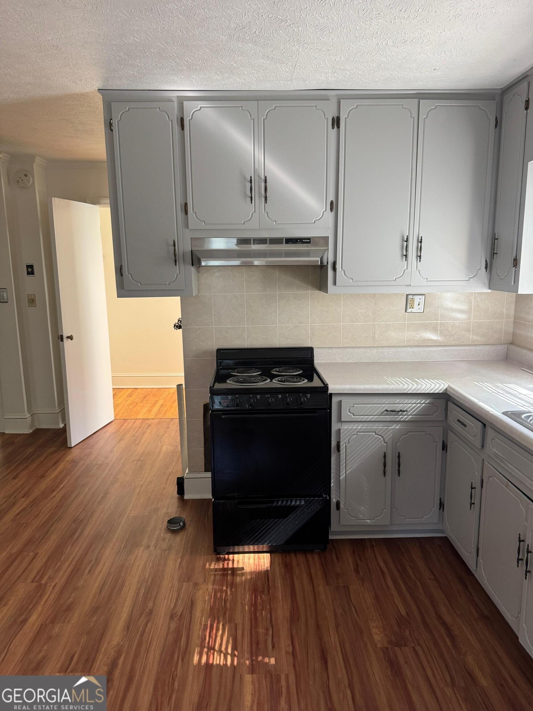 609 West Main Street Thomaston, GA 30286 - Photo 15 of 27 a kitchen with a sink and wooden floor