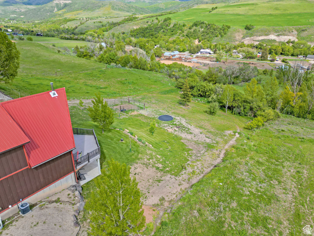 306 Spring Road Preston, ID 83263 - Photo 36 of 55 Property featuring a red metal roof, multi-level exterior deck, and a sloping, expansive grassy yard