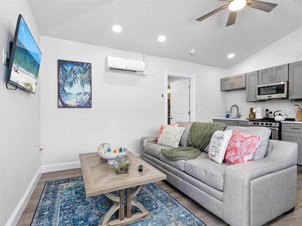 544 Canal Road Sarasota, FL 34242 - Photo 14 of 35 a living room with furniture and a flat screen tv