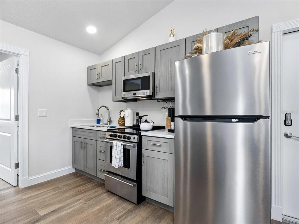 544 Canal Road Sarasota, FL 34242 - Photo 17 of 35 a kitchen with stainless steel appliances a refrigerator stove and microwave